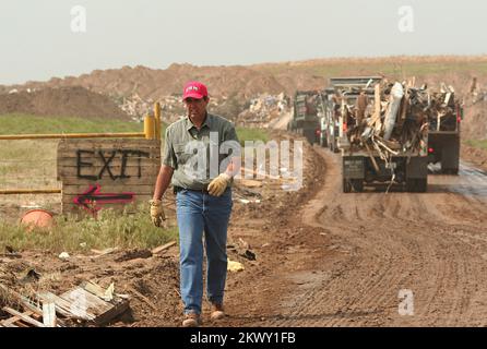 Tempêtes, tornades et inondations graves, Greensburg, KS 20 mai, 2007 - Mike Perkins, un employé du comté de Neaby Lawrence, aide à diriger le trafic au dépotoir de Greensburg. Les débris de la tornade 4 mai sont brûlés ou enfouis selon le matériau. Photographies relatives aux programmes, aux activités et aux fonctionnaires de gestion des catastrophes et des situations d'urgence Banque D'Images