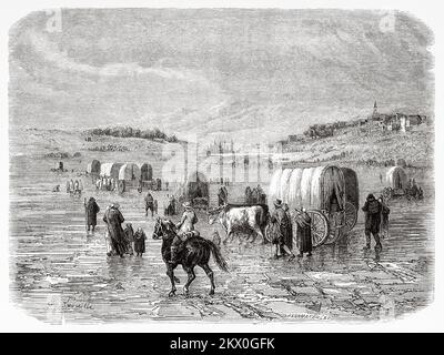 Une caravane d'immigrants se dirigeant vers l'ouest en 1860s. États-Unis d'Amérique. Voyages en Amérique du Nord par Louis Deville, États-Unis et Canada 1854-1855. Le Tour du monde 1861 Banque D'Images