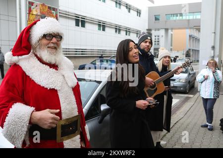 La chanteuse croate Maja Bajamic a dirigé le chant des chants de Noël et des chansons pour enfants devant les fenêtres du Département d'hématologie pédiatrique, d'oncologie et de transplantation de cellules souches hématopoïétiques du Centre hospitalier universitaire de Zagreb, à Zagreb, en Croatie, sur 23 décembre 2021. Photo: Zeljko Hladika/PIXSELL Banque D'Images