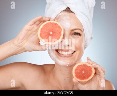 Femme, masque facial ou soin de la peau au pamplemousse sur fond de studio au Canada bien-être de santé, dermatologie organique ou visage vegan. Portrait, sourire ou Banque D'Images