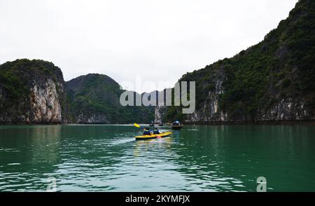 Touristes kayak dans émerald LAN Ha Bay, Ha long, Vietnam Banque D'Images