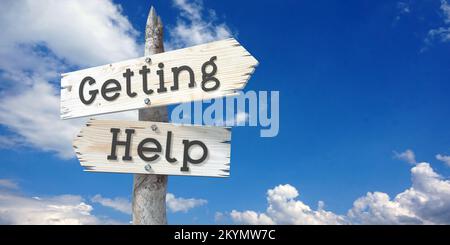 Obtenir de l'aide - panneau en bois avec deux flèches Banque D'Images