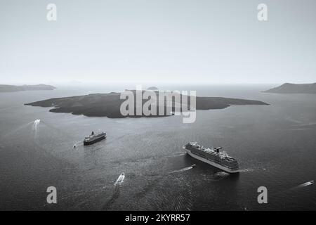 Santorini, Grèce - 16 septembre 2022 : vue panoramique de deux bateaux de croisière à côté du volcan et d'un beau ciel bleu à Santorini Grèce Banque D'Images