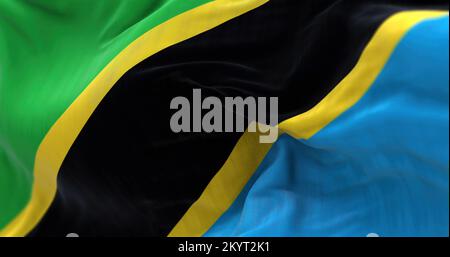 Vue rapprochée du drapeau national tanzanien agitant dans le vent. La République-Unie de Tanzanie est un pays d'Afrique de l'est. Fond texturé en tissu Banque D'Images