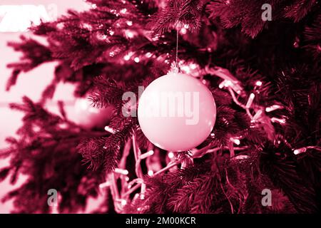 Composition de Noël. Beaucoup de décorations argentées pour arbres de Noël, vue de dessus. Couleur Viva Magenta. Démonstration des couleurs de 2023. Banque D'Images