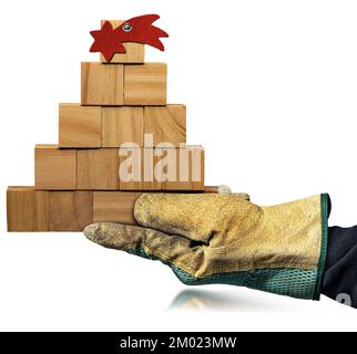 Main avec des gants de travail de protection tenant un petit arbre de Noël en bois, fait de petits cubes en bois avec une étoile de comète rouge, isolé sur fond blanc Banque D'Images