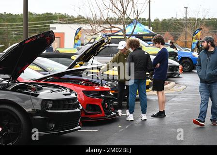 Durham, NC, USA, 3rd décembre 2022, Un groupe de jeunes hommes admirent le moteur d'une voiture de muscle moderne Camero lors de l'événement mensuel Cars and Coffee. Credit D Guest Smith / Alamy Live News Banque D'Images