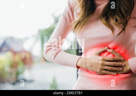 Malade femme malheureux avoir mal à l'estomac à la maison Banque D'Images