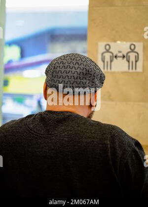 Adulte homme tête chauve, vue arrière du dos. Alopécie humaine ou perte de cheveux. Mise au point sélective, photo de rue. Homme tête chauve portant un chapeau Banque D'Images