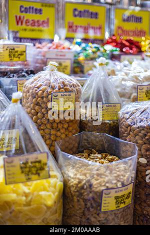 Ho Chi Minh ville, Vietnam - 10 novembre 2022: Noix, sucreries et fruits secs dans un marché à Saigon. Crème anglaise au pomme Mang et diverses graines et noix Banque D'Images