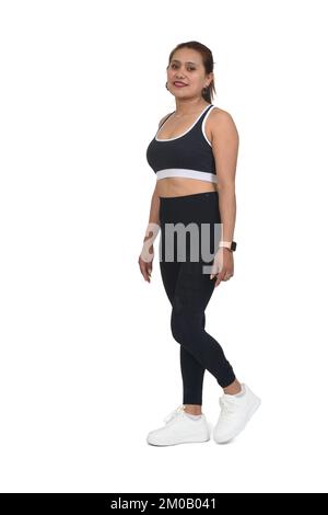 vue latérale d'une femme sportswear marchant sur fond blanc Banque D'Images