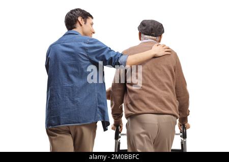 Vue arrière d'un jeune homme aidant un homme âgé avec un marcheur isolé sur fond blanc Banque D'Images