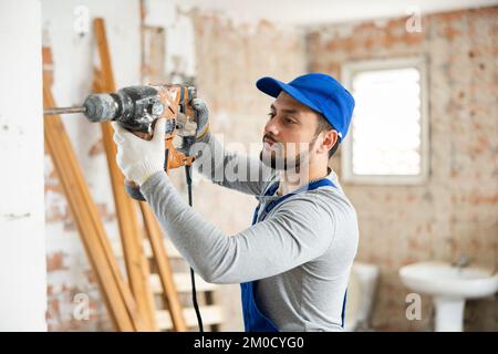 Constructeur confiant posant sur le chantier de construction intérieure Banque D'Images