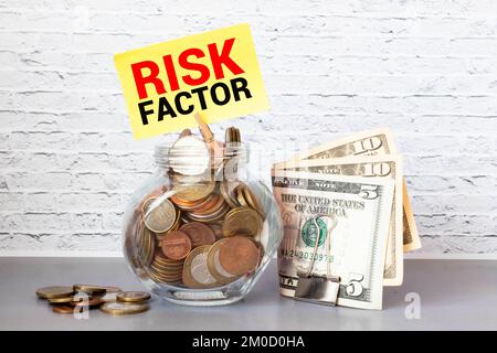 Texte du facteur de risque sur le bloc-notes ouvert près de l'horloge de bureau et notes adhésives jaunes Banque D'Images