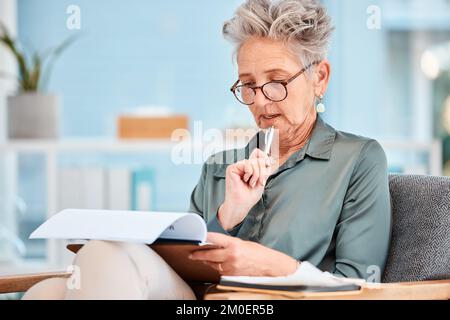 Penser, documenter et faire des affaires avec une femme âgée qui lit tout en étant assise sur une chaise au travail. Données, écriture et idée avec une femme mature PDG Banque D'Images