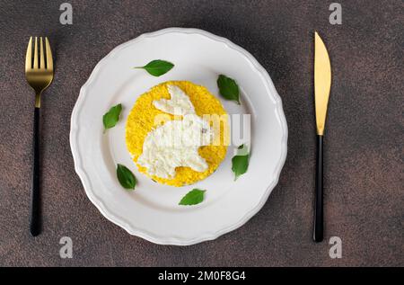 Salade feuilletée Mimosa pour le nouvel an 2023 avec thon en conserve, pommes de terre et carottes, lapin décoré d'œufs Banque D'Images