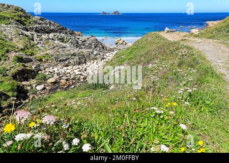 La mer et la falaise rochers, avec les Brison au loin, à la vallée de Cot, Porth Nanven, près de St Just, West Cornwall, Angleterre, Royaume-Uni Banque D'Images