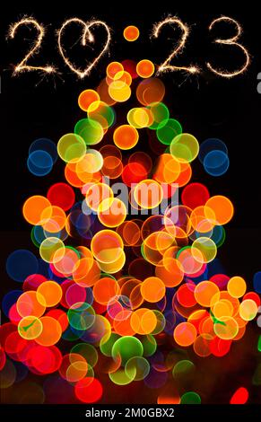Bokeh circulaire abstrait de Christmaslight. Bokeh s'allume sur fond noir. Bonne année 2023 et arbre de noël. Banque D'Images