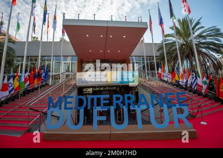 Marseille, France. 06th décembre 2022. L'entrée du Parc Chanot avec l'inscription 'Méditerranée du futur' et les drapeaux des délégations invitées. Organisé au Parc Chanot, le 'Méditerranée du futur - Acte V' est une réunion internationale qui rassemble les pays méditerranéens sur le thème des questions écologiques et permet le partage d'expériences et de solutions. Crédit : SOPA Images Limited/Alamy Live News Banque D'Images