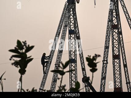 Mumbai, Inde. 06th décembre 2022. Un ouvrier monte sur une tige d'acier pendant la construction d'un tour d'amusement devant le Mahim (zone dans le sud de Mumbai) à Mumbai. La foire sera célébrée du 8th décembre 2022 au 18th décembre 2022 en l'honneur de Soufi saint PIR Makhddom Mahimi. (Photo par Ashish Vaishnav/SOPA Images/Sipa USA) crédit: SIPA USA/Alay Live News Banque D'Images