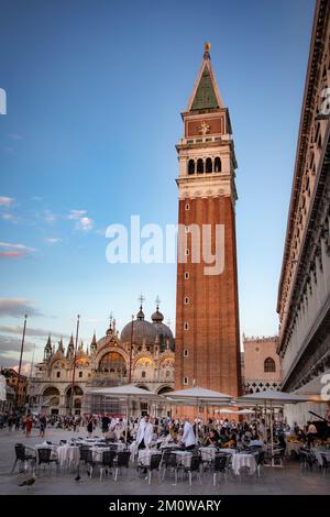 Le restaurant prépare ses tables au crépuscule sur la Piazza San Marco, Venise, Italie. Banque D'Images