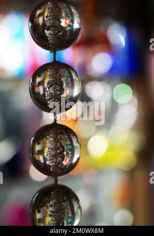 Un brin de perles de verre suspendues sur un fil. Arrière-plan bokeh Banque D'Images