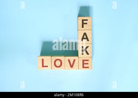 Faux amour et datation Scam concept. Jeu de blocs en bois de mots croisés. Banque D'Images