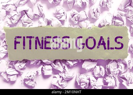 Signe d'écriture à la main objectifs de forme physique. Mot pour la graisse lâche construire muscle obtenir plus de conditionnement Banque D'Images
