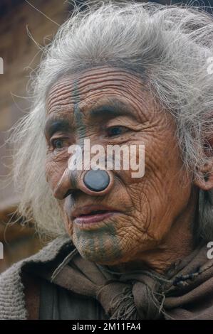 Ziro, Arunachal Pradesh, Inde - 11 13 2010 : Portrait d'une belle ancienne femme tribale d'Apatani avec des tatouages faciaux traditionnels et des prises de nez Banque D'Images