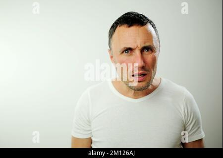 Portrait émotionnel gars se sentant naufrage coeur essoufflement au sujet du stress émotionnel sensations isolées sur fond gris blanc studio, peur personne, horreur panique concept d'attaque de panique homme Banque D'Images