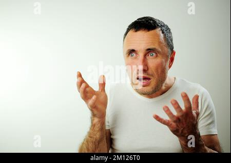 Portrait émotionnel gars se sentant naufrage coeur essoufflement au sujet du stress émotionnel sensations isolées sur fond gris blanc studio, peur personne, horreur panique concept d'attaque de panique homme Banque D'Images