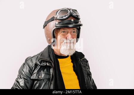 Portrait d'un motard homme barbu en cuir et d'un casque de moto souriant, isolé sur fond blanc Banque D'Images