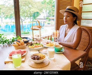 Femmes asiatiques thaïlandaises ayant un petit déjeuner de luxe dans l'hôtel. Banque D'Images