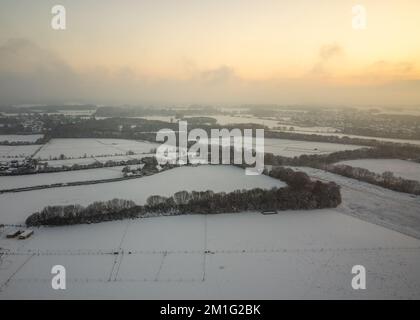 Gravesend, Royaume-Uni. 12th décembre 2022. Le soleil commence à se coucher sur le paysage brumeux et neigeux à Gravesend dans le Kent. Banque D'Images