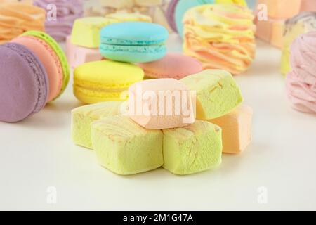 Assortiment de sucreries : macarons, guimauves et zéphans. Desserts colorés faits maison pour le présent. Banque D'Images