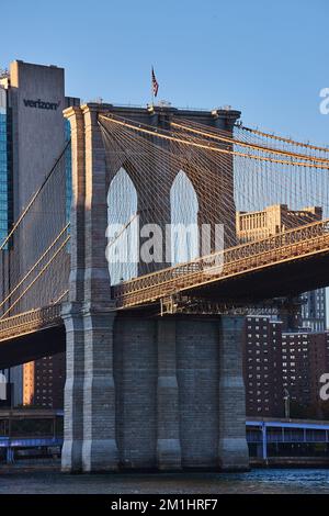 Détail du pont de Brooklyn en lumière dorée avec vue sur la ville en arrière-plan Banque D'Images