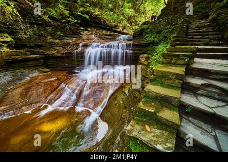 L'escalier en pierre passe par une superbe cascade dans le nord de l'État de New York avec un couple à distance Banque D'Images