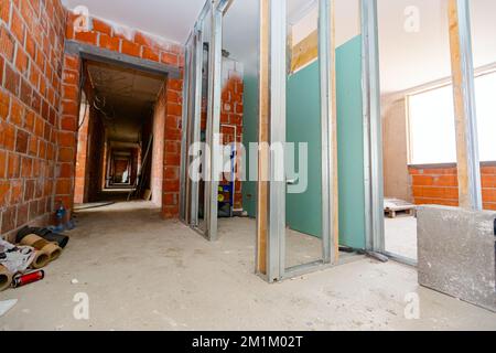 Vue sur le cadre de piliers profilés verticaux en métal et en bois pour le montage de cloisons, bâtiment résidentiel en construction. Banque D'Images