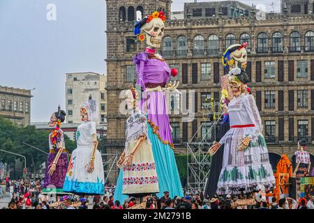 Les foules se rassemblent autour de sculptures géantes de Catrina, la mariée squelette, pendant le festival Megaofrenda de Zocalo pour célébrer le début de la journée des morts sur la Plaza de la Constitucion, 28 octobre 2022 à Mexico, Mexique. Banque D'Images