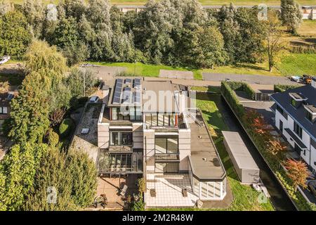 une vue aérienne d'une maison avec des arbres et des buissons à l'avant - image est prise d'en haut, en regardant vers le bas Banque D'Images