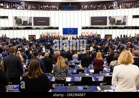 14 December 2022, France, Straßburg: Members as well as visitors of the European Parliament commemorate the Ukrainian victims of Russia's war of aggression against Ukraine during a minute of silence at the Sakharov Prize ceremony, together with Ukrainian President Volodymyr Selenskyj, who was joined by video. Today, the European Parliament will award the Sakharov Prize to the Ukrainian people and vote on financial aid of nearly 720 million euros for seven EU countries - including Germany - hit by natural disasters in 2021. It will also hold a debate with the EU Commission and the Czech preside Stock Photo