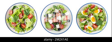 Assiettes avec différentes salades sur fond blanc Banque D'Images