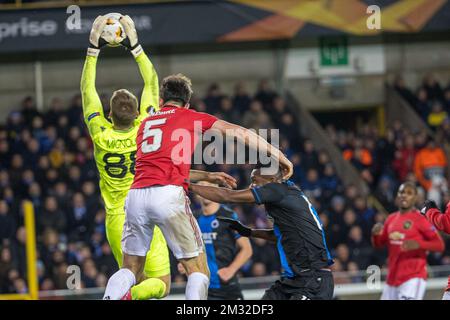 Le capitaine Harry Maguire de Manchester United , le gardien de but du club Simon Mignolet et le joueur Simon Deli du club se battent pour le ballon lors d'une partie des 1/16 finales de l'UEFA Europa League entre le club de football belge Club Brugge et le club anglais Manchetser United, à Bruges, le jeudi 20 février 2020. BELGA PHOTO KURT DESPLENTER Banque D'Images