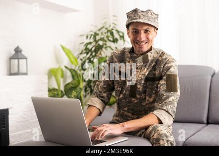 Surveillance et contrôle du concept d'information opposé, Soldier en uniforme de camouflage travaillant sur ordinateur portable pour opération d'information Banque D'Images