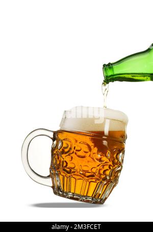 verser de la bière dans une tasse sur fond blanc Banque D'Images