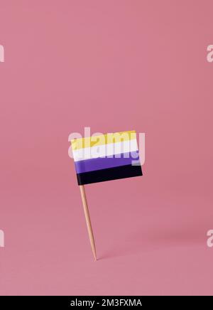 un drapeau de fierté non binaire attaché à un poteau en bois debout sur un fond rose, avec un peu d'espace sur le dessus Banque D'Images