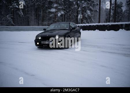 12-12-2022 Riga, Lettonie une voiture roule sur une route enneigée. . Banque D'Images