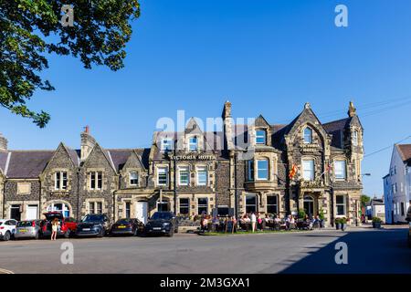 L'hôtel Victoria de Bamburgh, un village côtier de Northumberland sur la côte nord-est de l'Angleterre, les clients buvant dehors lors d'une journée ensoleillée Banque D'Images