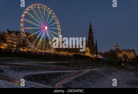 Édimbourg, Écosse, Royaume-Uni, 15th décembre 2022. Noël : le marché de Noël et la grande roue sont illuminés au crépuscule avec de la neige sur le sol dans Princes Street Gardens. Crédit : Sally Anderson/Alay Live News Banque D'Images