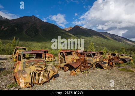 Une gamme de camions rouillés abandonnés après la guerre qui rouillent dans le désert pendant l'été dans le nord du Canada Banque D'Images